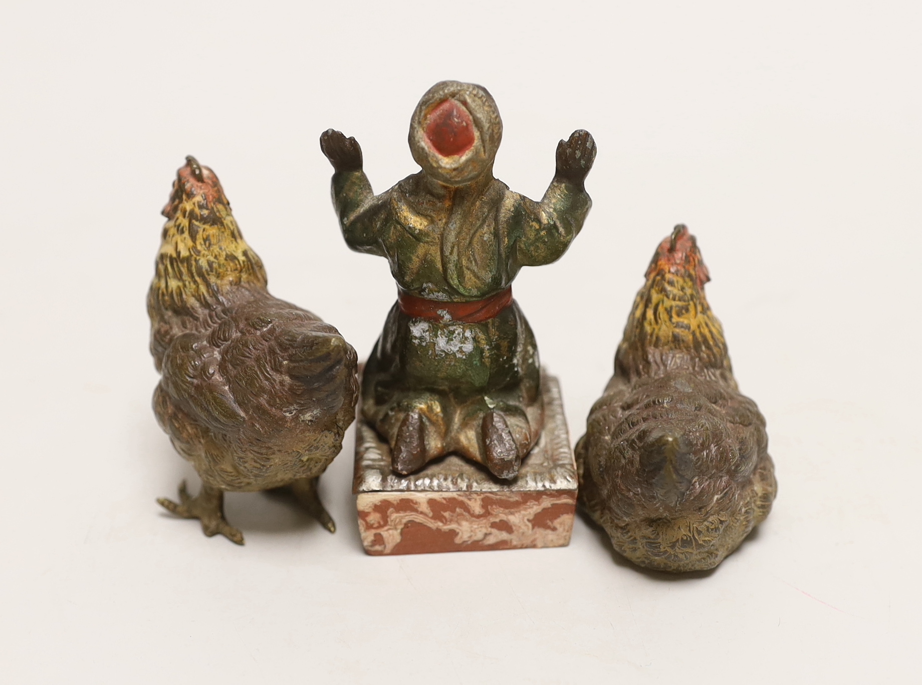 Two Austrian cold painted bronze chickens and a painted metal kneeling man, tallest 9cm